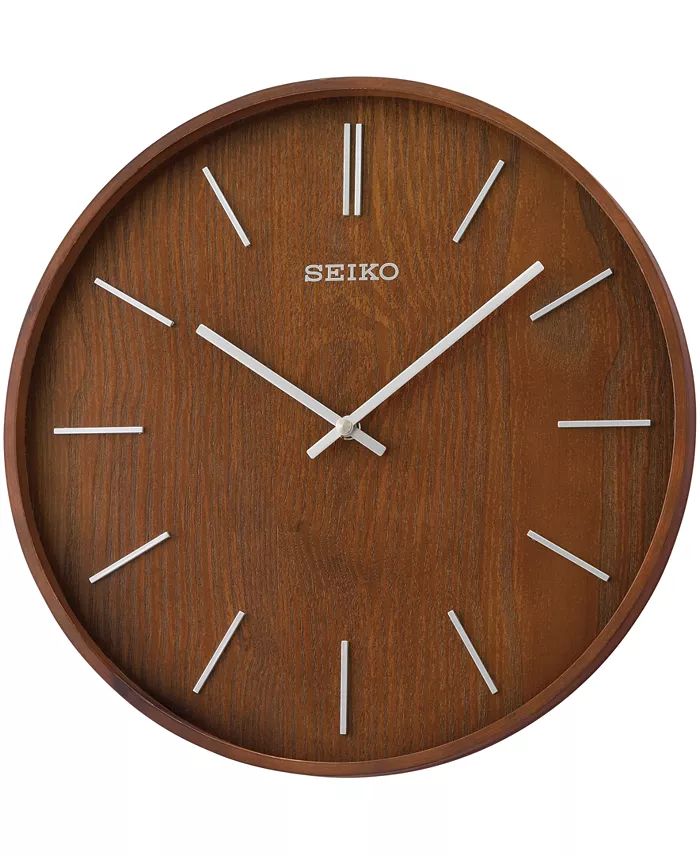 A brown wall clock with silver lines as numbers