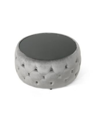 velvet design with diamond tufting and a tempered glass top is offered as a modern glam ottoman