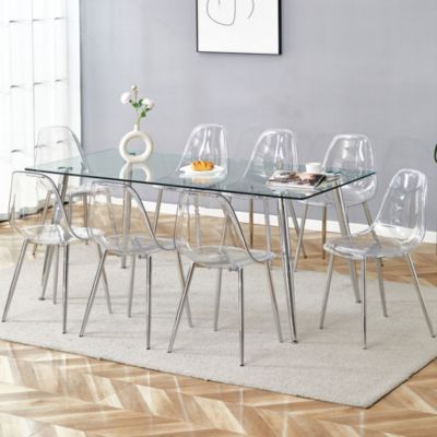 Table and chair set.Modern rectangular glass dining table with tempered glass countertop and silver metal legs, paired with multiple transparent high-quality PET dining chairs with silver legs.