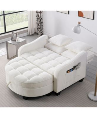 Beige two-seater sofa with chaise, storage footrest, and throw pillows