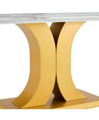 A modern minimalist dining table. Imitation marbled glass tabletop. Gold MDF table legs for kitchen and living room