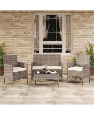 4-Piece Rattan Patio Furniture Set with Upholstered Sofa and Coffee Table