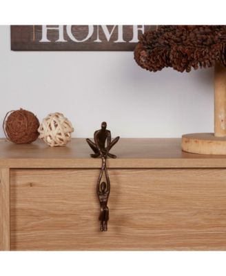 Man Lifting Woman from Ledge Bronze Sculpture