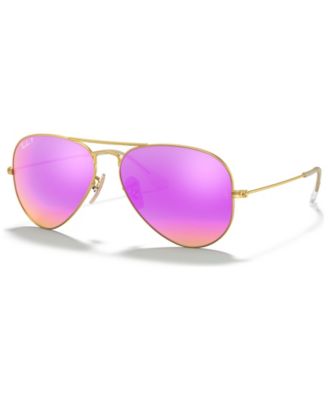 A pair of gold sunglasses with pink lenses