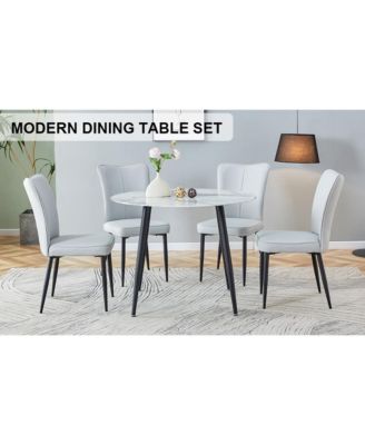 Table and chair set. Large modern white imitation marble patterned round table with black metal legs. Nice minimalism, comfortable seats and black metal legs.