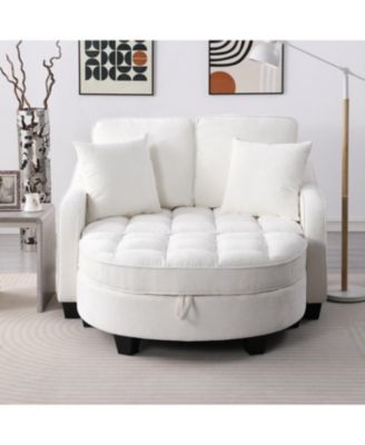 Beige two-seater sofa with chaise, storage footrest, and throw pillows