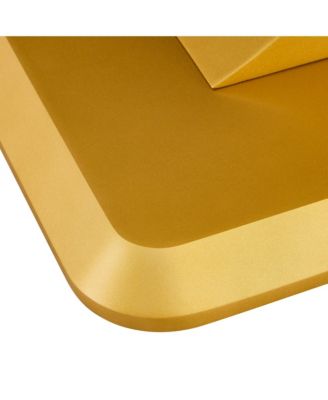 A modern minimalist dining table. Imitation marbled glass tabletop. Gold MDF table legs for kitchen and living room