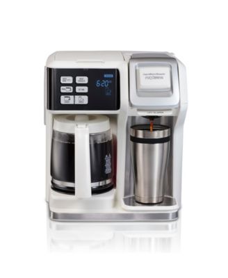 On one side, you'll find the single-serve option, equipped with a removable cup rest that accommodates travel mugs and offers compatibility with both coffee pods and ground coffee. On the other side, the carafe option boasts a programmable timer, allowing you to wake up to a fresh pot of coffee at your desired time.