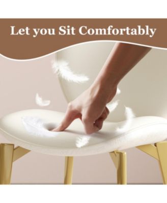  Set of 2 PU leather dining chairs with gold legs and textured backrest.