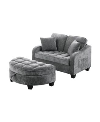 Grey two-seater sofa with chaise, storage footrest, and two pillows