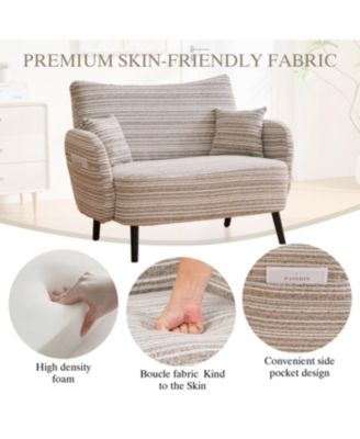 Modern two-seater sofa with armrests, pillows, and storage pockets.