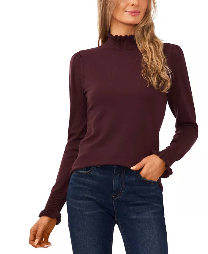 A woman wearing a CeCe Dark Cocoa Mock Neck Long Sleeve Sweater with a pair of dark blue jeans