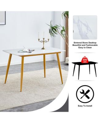 Table and chair set.A morden table with White imitation marble patterned stone burning tabletop with golden metal legs.Paired with 4 chairs with PU leather backrest and black metal legs.