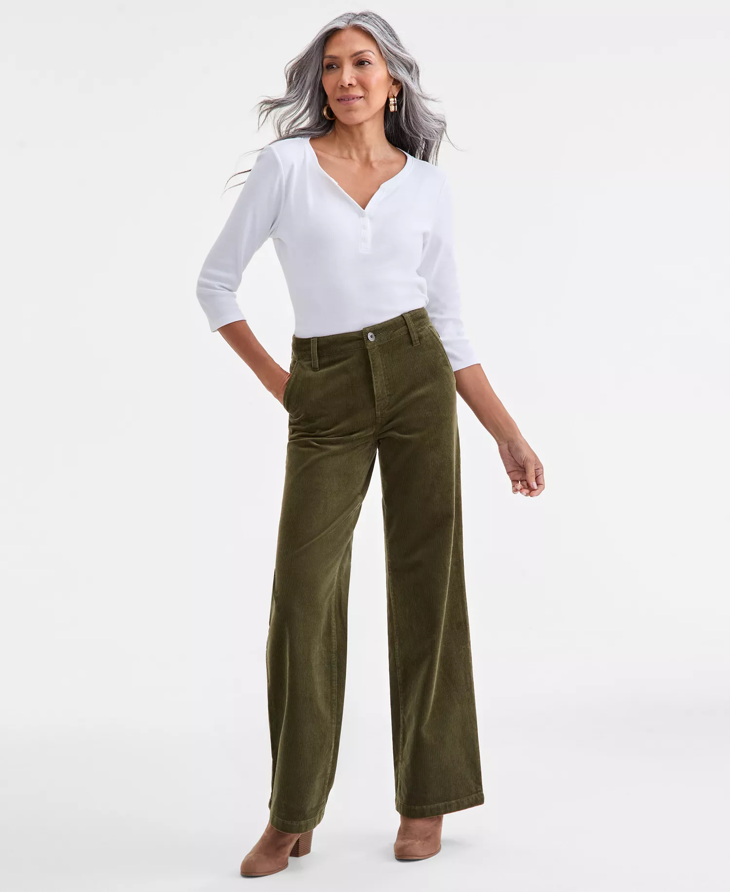 A woman wearing green corduroy pants