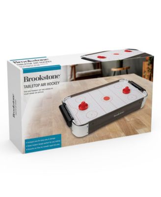 Brookstone - Battery operated air surface, 2 strikers, 2 pucks, and scorekeeping feature