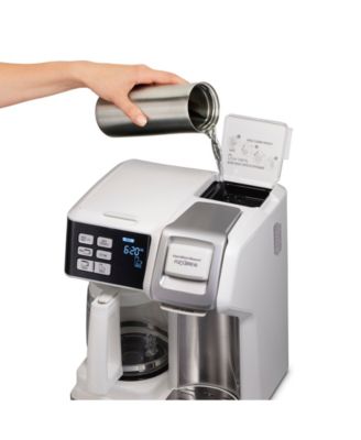 Experience the ultimate in coffee-making convenience with the Hamilton Beach FlexBrew 12-Cup Coffee Maker. This versatile machine allows you to brew a full pot or a single cup, whether you prefer ground coffee or K-Cups. Its sleek white design effortlessly complements any kitchen decor, making it a stylish addition to your countertop.