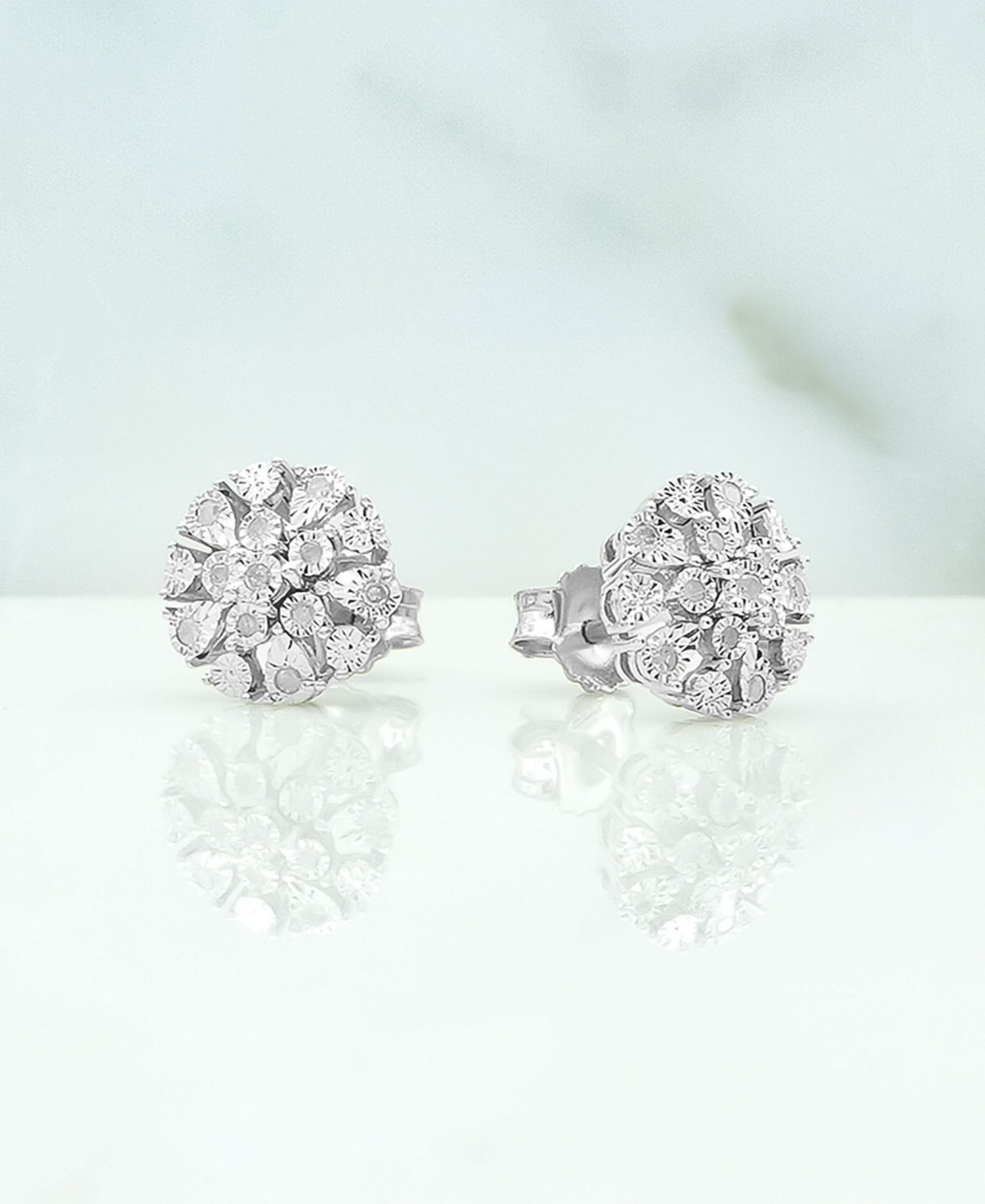 Diamond Flower Burst Stud Earrings (1/10 ct. t.w.) in Sterling Silver