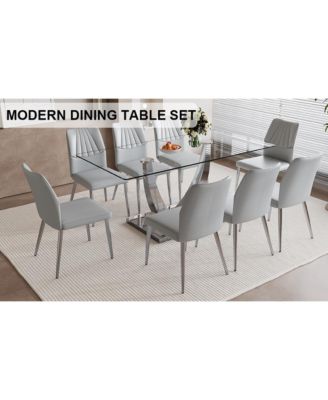 Table and chair set.Contemporary, minimalist rectangular dining table featuring a clear tempered glass top and sleek silver legs. Paired with chairs made of PU material cushion and silver metal legs.