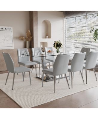 Table and chair set.Contemporary, minimalist rectangular dining table featuring a clear tempered glass top and sleek silver legs. Paired with chairs made of PU material cushion and silver metal legs.