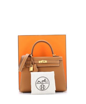 Бывшая в употреблении сумочка HERMÉS Kelly 25 коричневого цвета с золотой фурнитурой
