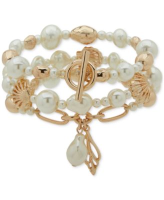 Трехрядный эластичный браслет Anne Klein с имитацией жемчужной раковины золотистого цвета и мотивом в виде ракушки 