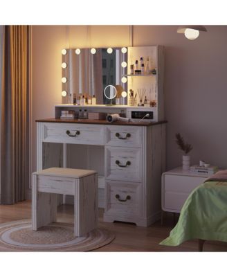 Vanity desk for bedroom with lights, drawers, shelves, stool, and mirror.