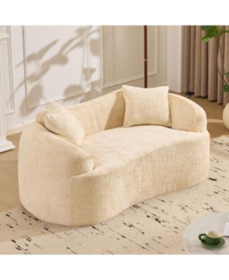Beige curved two-person compress sofa with armrests and two pillows.