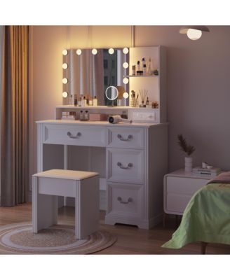 Vanity desk for bedroom with lights, drawers, shelves, stool, and mirror.