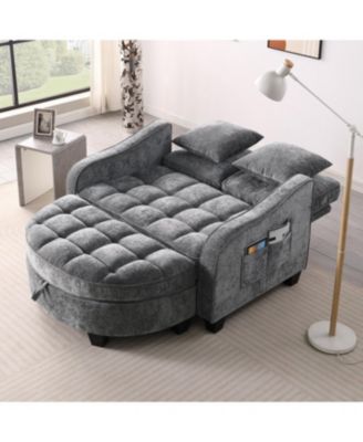 Grey two-seater sofa with chaise, storage footrest, and two pillows