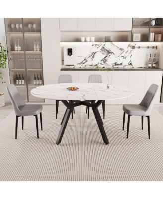 Expandable circular dining table set with 4 cushioned chairs.