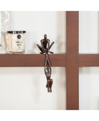 Man Lifting Woman from Ledge Bronze Sculpture