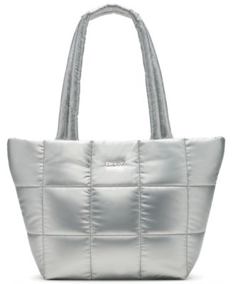 Photo 1 of DKNY Giania  Silver Women's  Tote
17" W x 11/5" H x 6" D
Zipper closure
10.5" strap drop
1 interior slip 1 zip pocket
Logo on front, Silver-tone hardware
Nylon