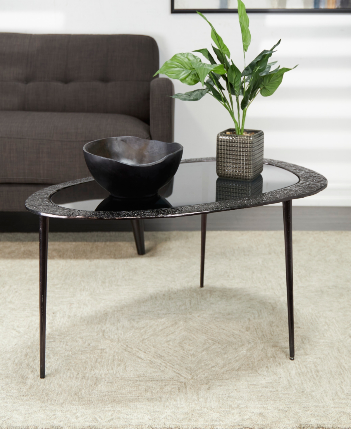 Shop Rosemary Lane 30" X 25" X 18" Aluminum Abstract Oval Shaped Shaded Glass Top And Detailed Engravings Coffee Table In Black