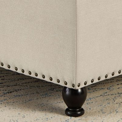 Beige upholstered storage ottoman with wooden legs