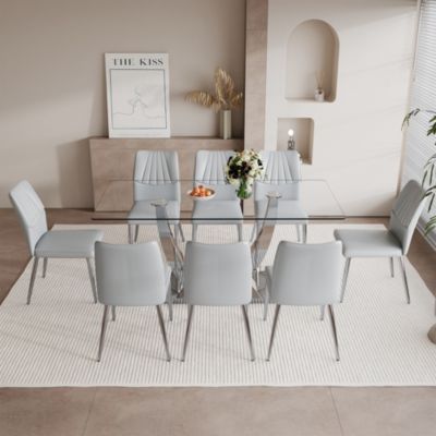 Table and chair set.Contemporary, minimalist rectangular dining table featuring a clear tempered glass top and sleek silver legs. Paired with chairs made of PU material cushion and silver metal legs.