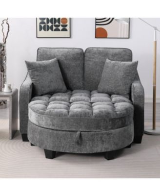 Grey two-seater sofa with chaise, storage footrest, and two pillows