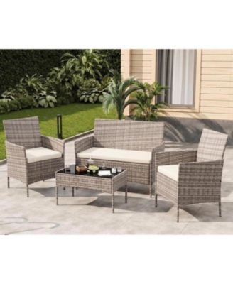 4-Piece Rattan Patio Furniture Set with Upholstered Sofa and Coffee Table