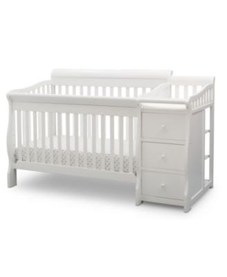 white crib with changing table
