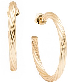 Swirled large hoop earrings plated in matte, 18k gold.