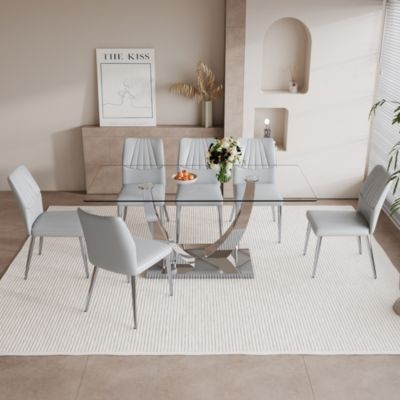 Table and chair set.Contemporary, minimalist rectangular dining table featuring a clear tempered glass top and sleek silver legs. Paired with chairs made of PU material cushion and silver metal legs.
