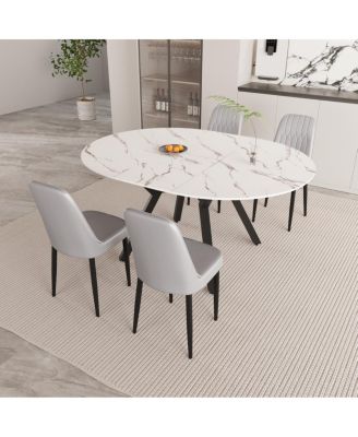 Expandable circular dining table set with 4 cushioned chairs.