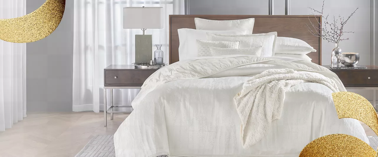 A large bed with white shimmering linens