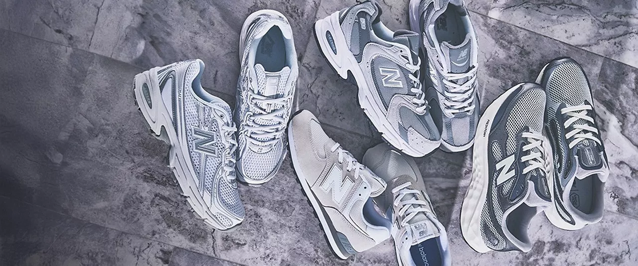 4 pairs of grey sneakers on a gray background